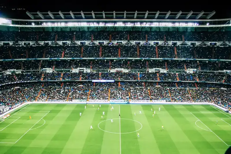 Football stadium under bright floodlights